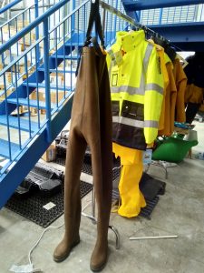 Hang waders with the boots on the floor to avoid stretching out the fabric.